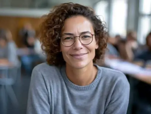 Vecteezy Smiling Woman Teacher With Glasses In A Vibrant Classroom 43536109 (nxpowerlite)